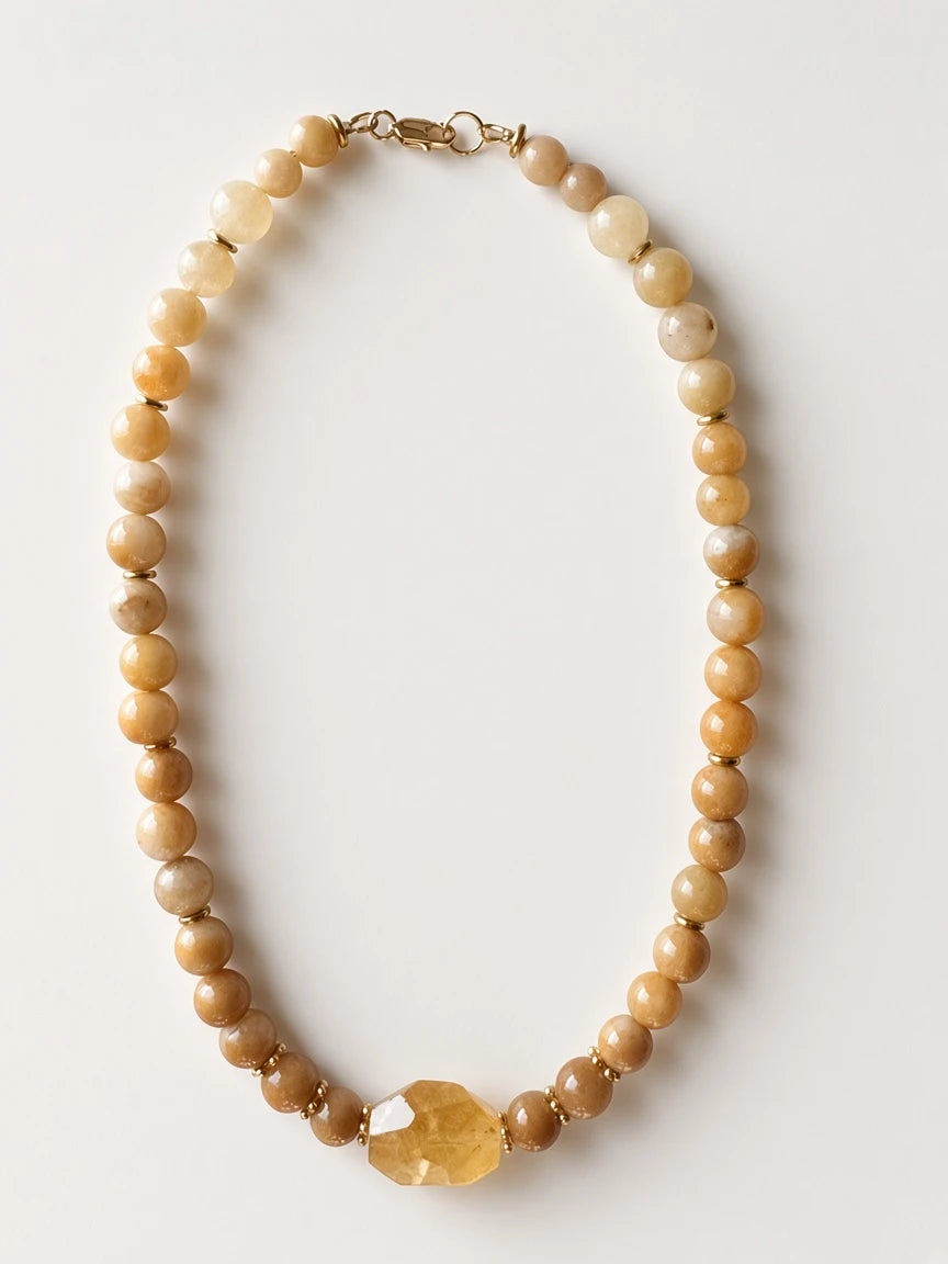 Hue La La Gems beaded necklace featuring honey-yellow jade beads, gold-tone spacers, and a faceted citrine centerpiece.