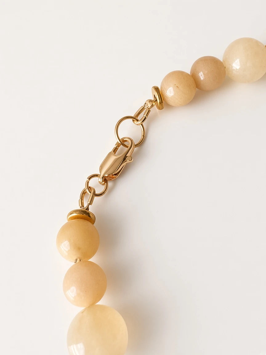 Hue La La Gems yellow jade beaded necklace featuring a secure gold-tone lobster clasp and polished metal hardware.